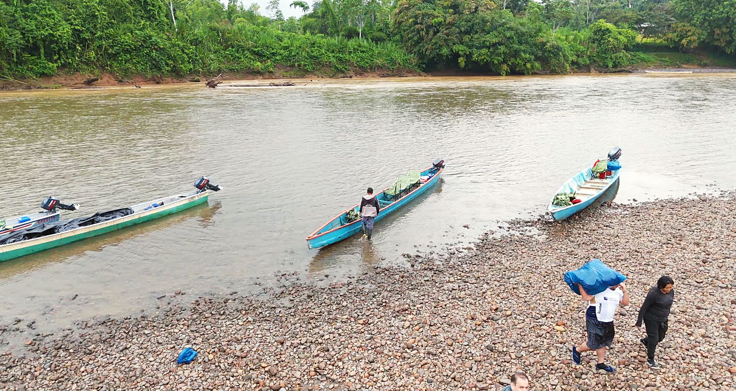 Canoes landing on the gravel riverbank